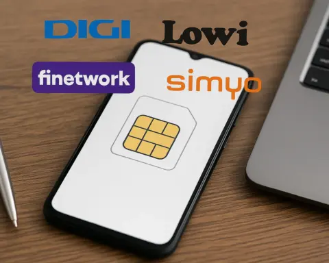 Logotipos de OMV como DIGI, Lowi, Finetwork y simyo flotando sobre un smartphone en una mesa de madera.